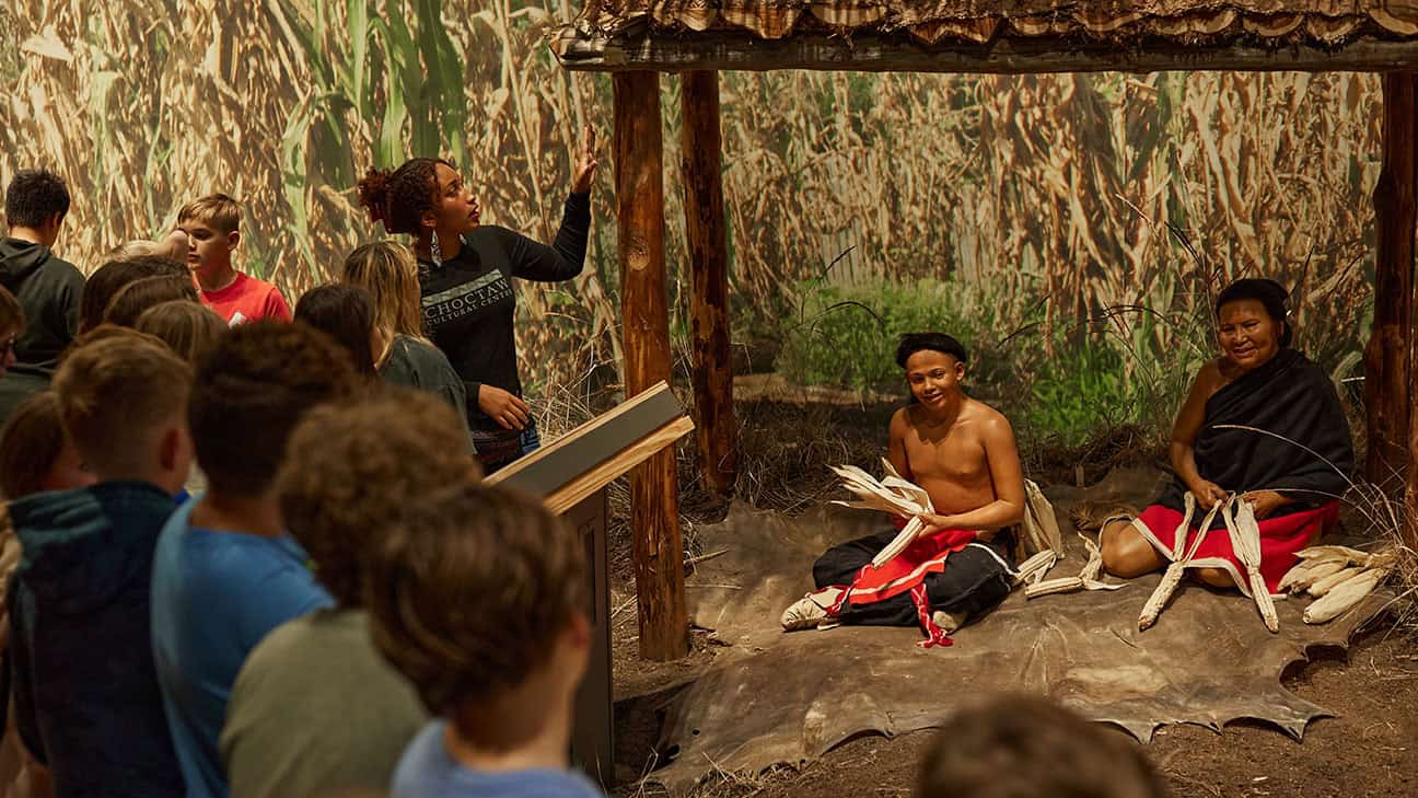 Choctaw Cultural Center exhibit with children standing around.