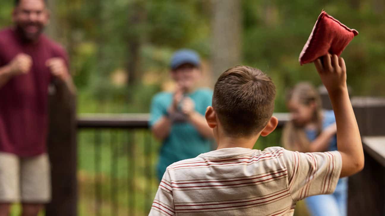 A family playing corn hole.
