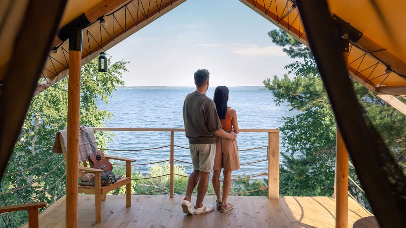 A couple sitting in front of an overlook.