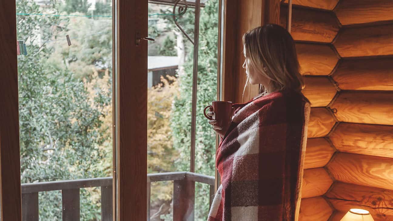 A person looking outside of a tiny home.