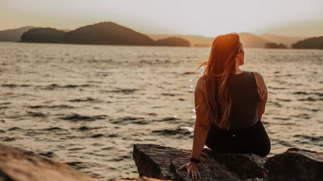 A person sitting next to the water.